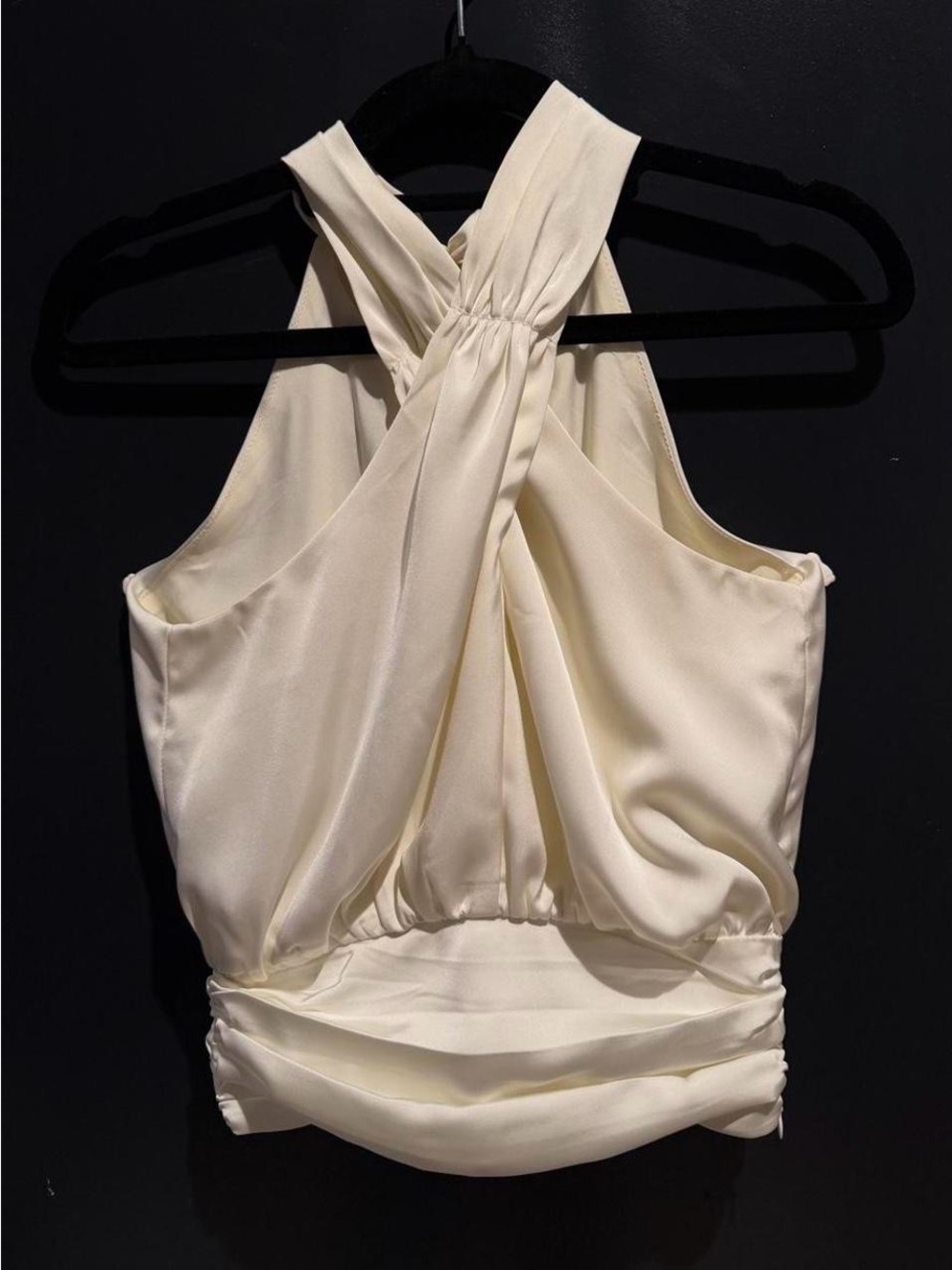 Cream satin halter top with a twist-back detail